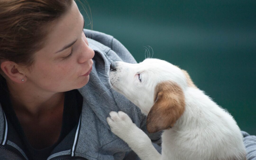 Woman blowing a kiss to her puppy