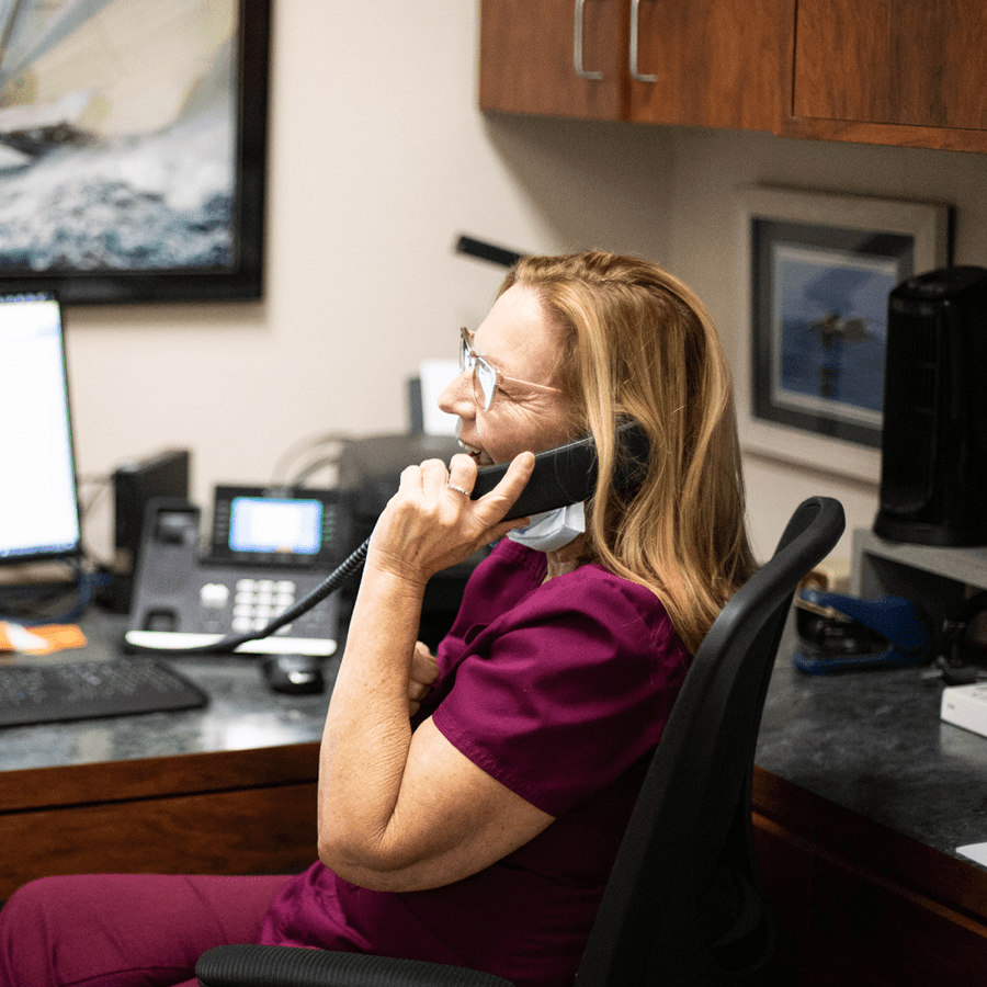 A happy veterinary CSR on the phone