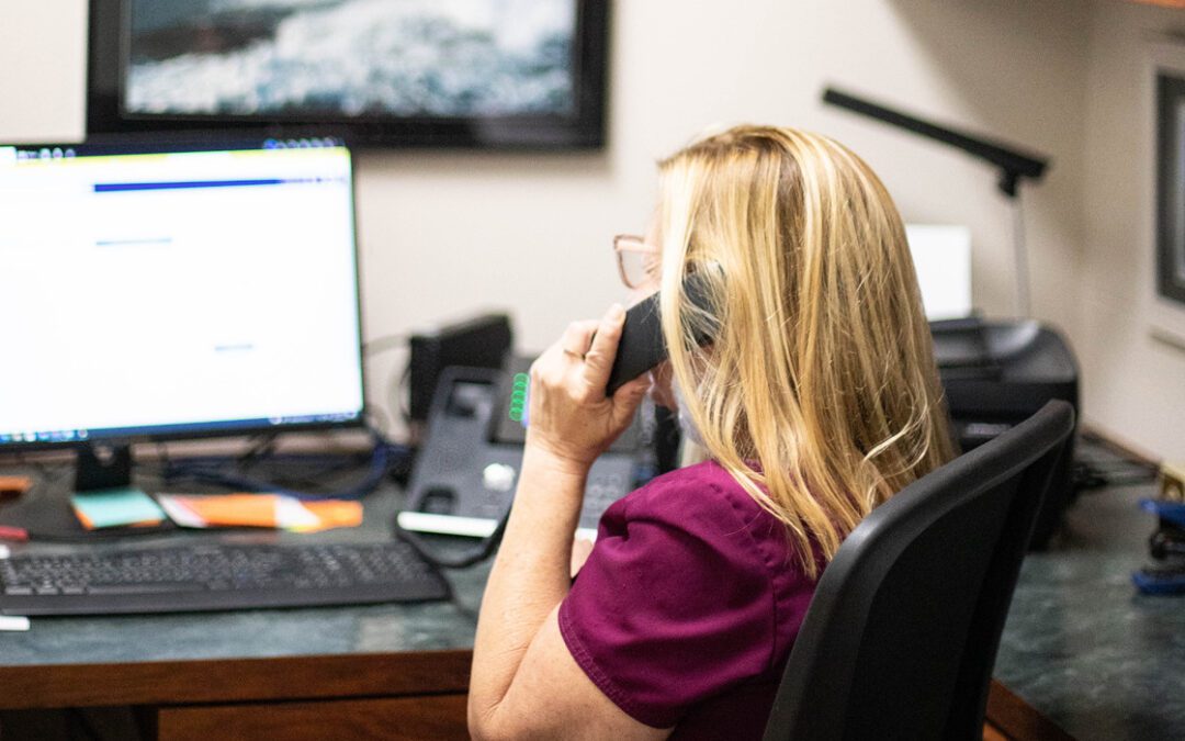 A happy CSR on the phone in their office
