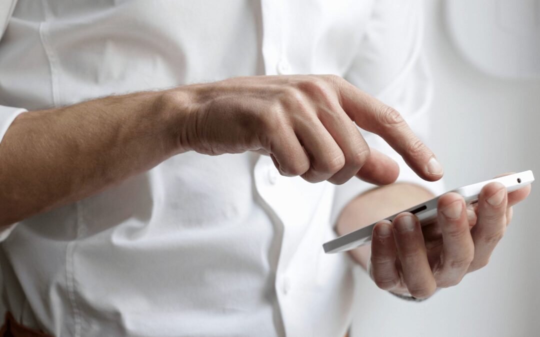 Man pressing the screen on his phone