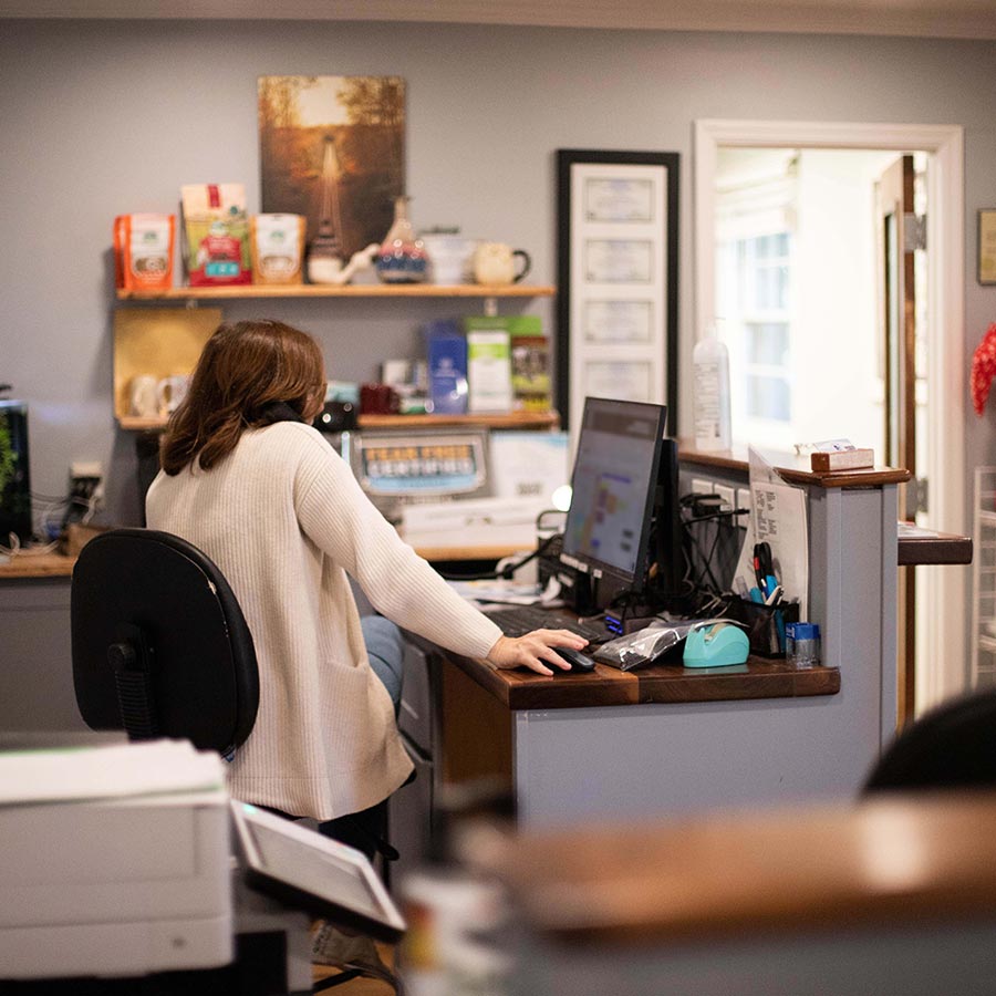 veterinary-team-member-using-phone-at-front-desk-1608 veterinary team member using phone at front desk